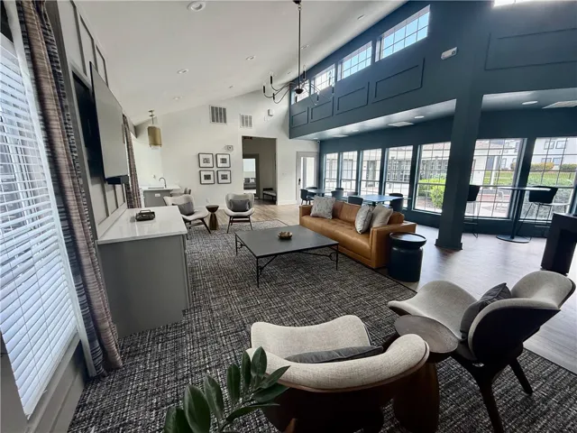 Vaulted ceilings amplify this generously scaled gathering space, offering abundant natural light.
