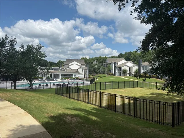 A community pool and green space offer leisure and recreation.