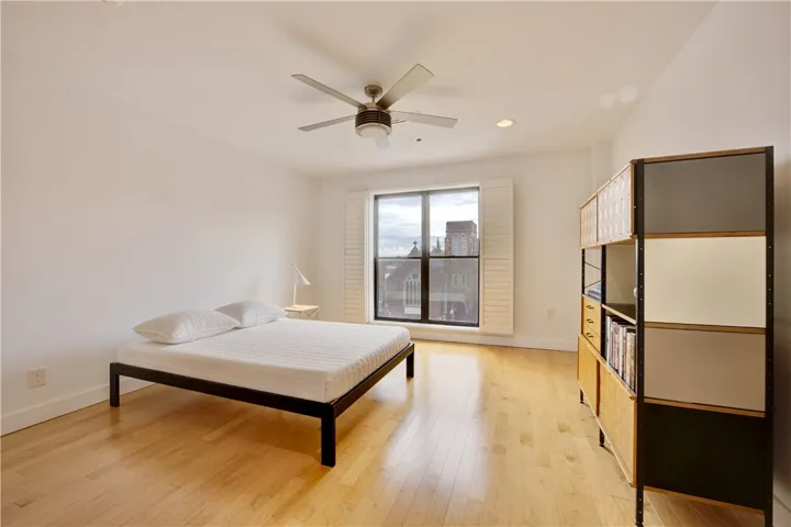 A quiet retreat featuring gleaming hardwood floors and ample natural light from the large window.