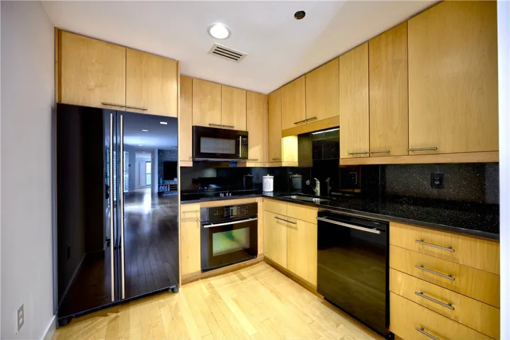A well-equipped kitchen features a suite of modern appliances and light-toned cabinetry.