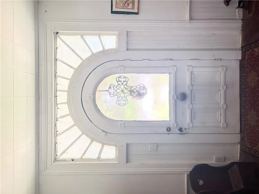 A classic front entry with an elegant transom window, offering a timeless welcome.