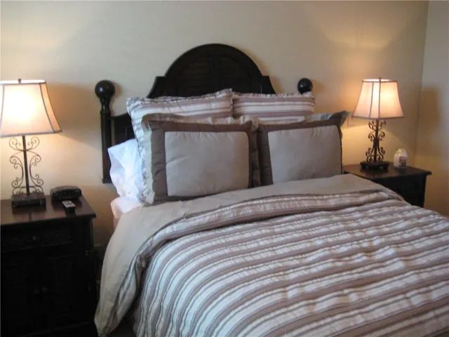 Comfortable sleeping quarters provide a peaceful retreat with bedside lighting.
