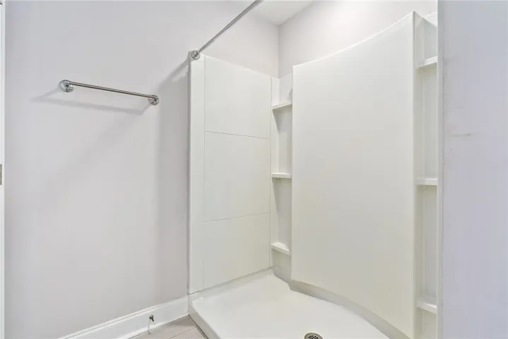 A well-appointed, shower enclosure provides convenience in a refreshed bathroom setting.