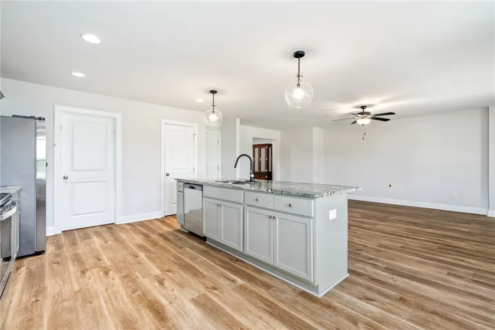 A well-lit kitchen with a central island and a functional open floorplan.