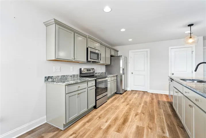 Culinary dreams come alive in this kitchen featuring abundant cabinetry and sleek granite countertops.