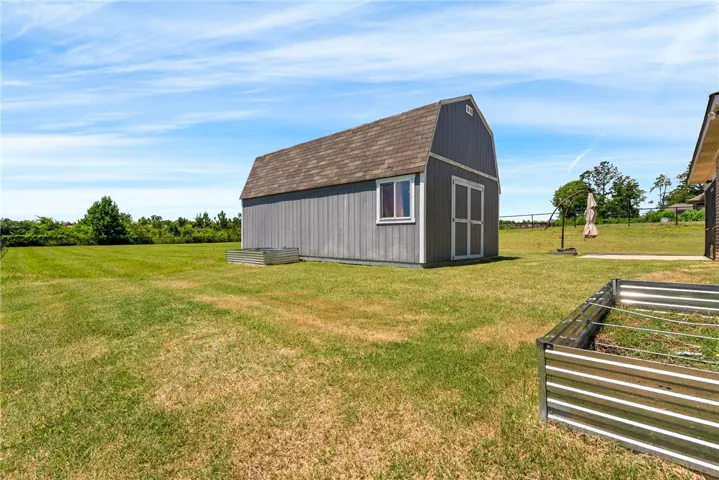 A like new shed provides ample outdoor storage on a generous green expanse.