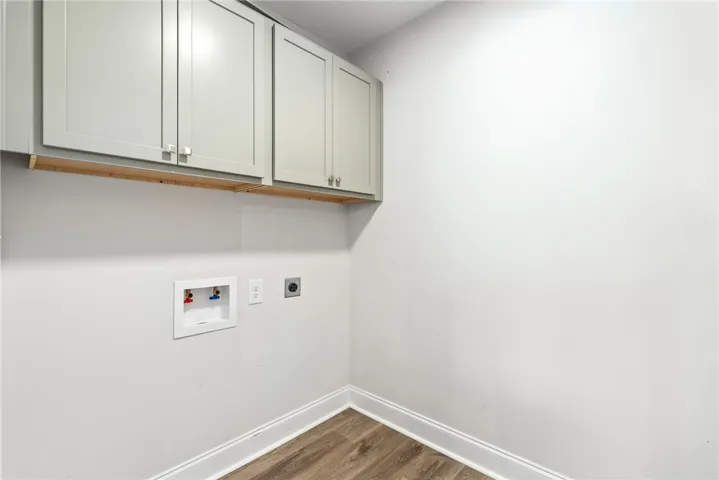 Functional laundry room offers ready connections and ample storage for daily convenience.