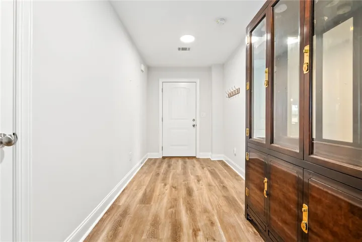 A well-lit entry hall with robust flooring welcomes you into the residence.