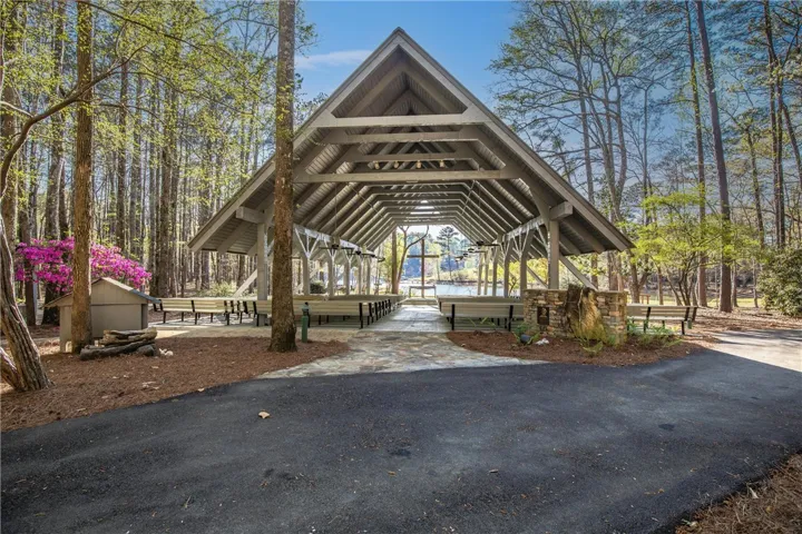 An inviting open-air pavilion frames serene lake views, perfect for gatherings.