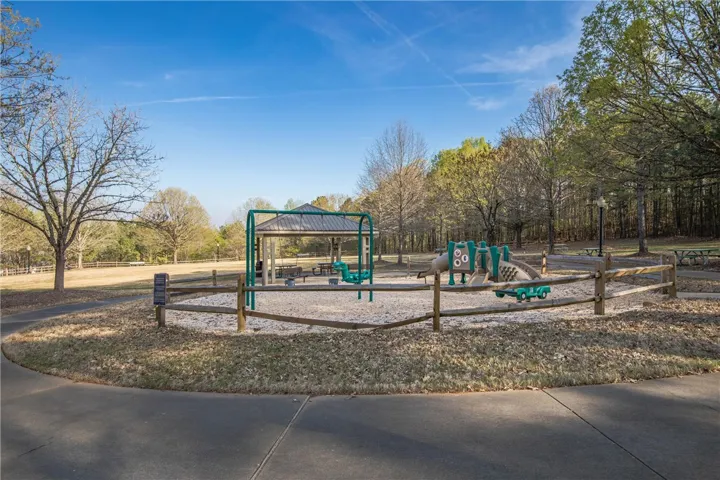 A community playground and picnic area offer ample space for recreation and relaxation amidst verdant surroundings.