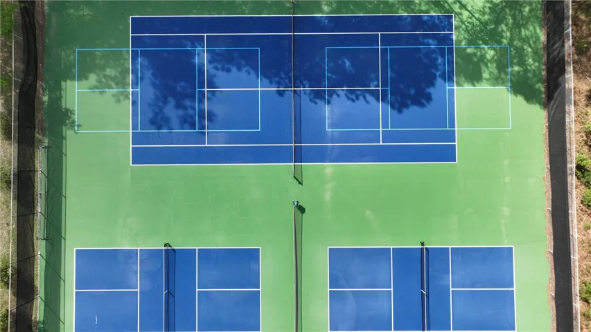 Sporting amenities include multiple well-maintained courts with distinct playing surfaces, offering recreational opportunities.