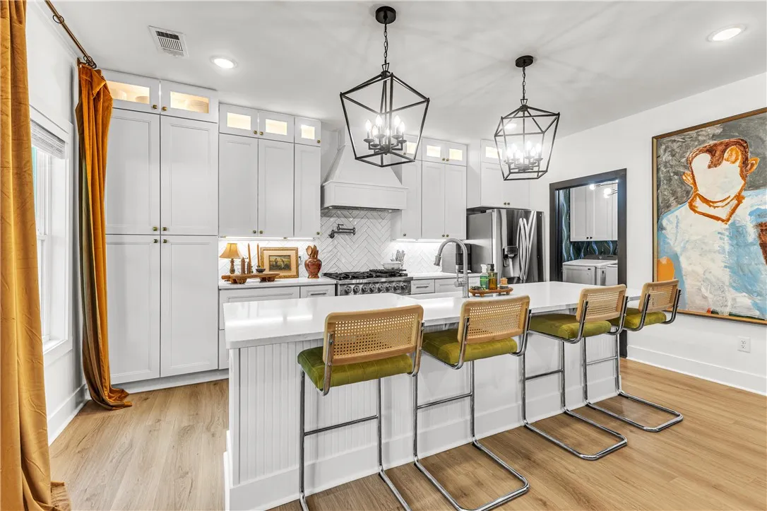 Culinary excellence awaits in this well-appointed kitchen, featuring a spacious island and gleaming stainless steel appliances.
