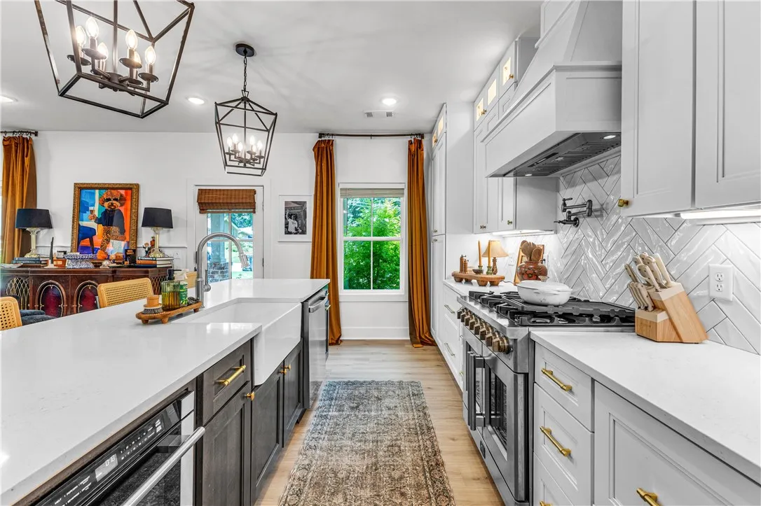 Culinary adventures await in this naturally illuminated kitchen, featuring an expansive island with a farmhouse sink.