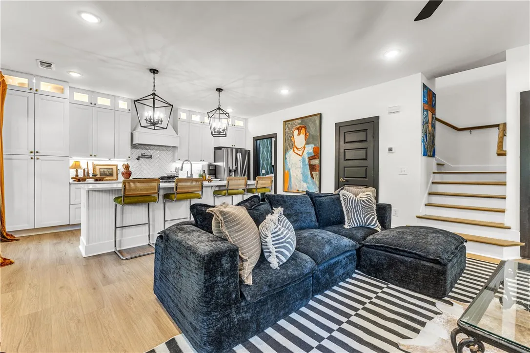 An open concept design seamlessly connects the culinary space with a cozy living area.