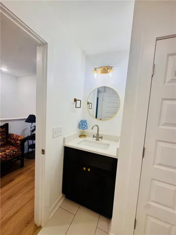 A compact vanity with modern fixtures complements the functional design of this convenient half bath.