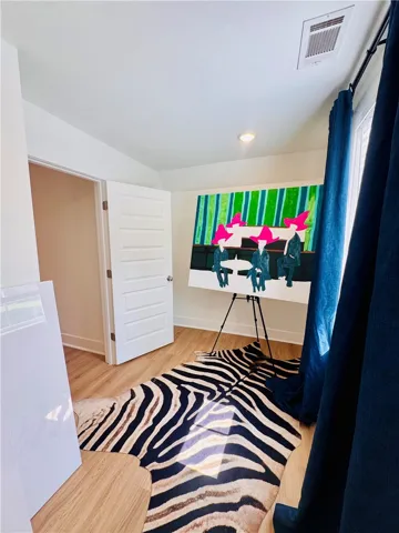 Hardwood flooring and an artistic flair define this inviting room.