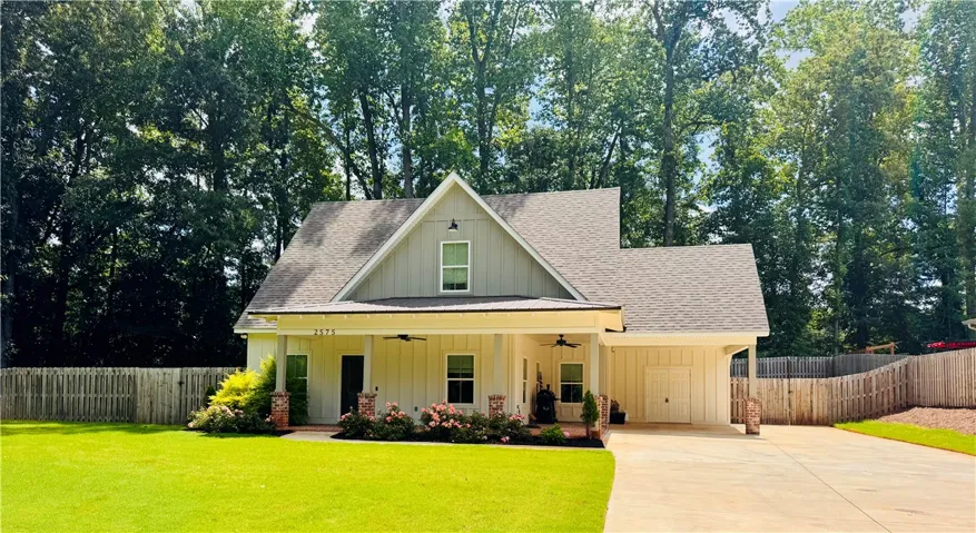 A welcoming front porch with ceiling fans graces this charming modern farmhouse.