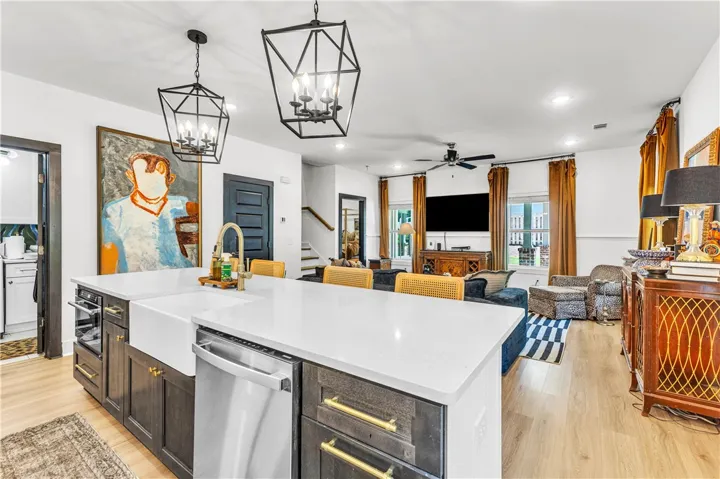 A gourmet kitchen island with a farmhouse sink anchors this open-concept living space, blending modern convenience with relaxed comfort.