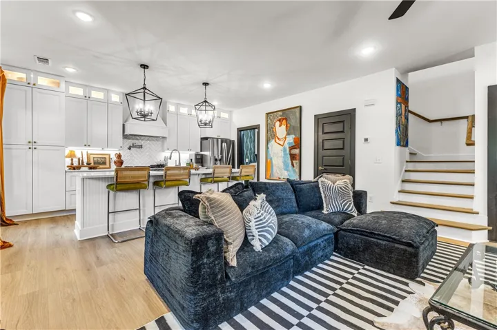 An open concept design seamlessly connects the culinary space with a cozy living area.