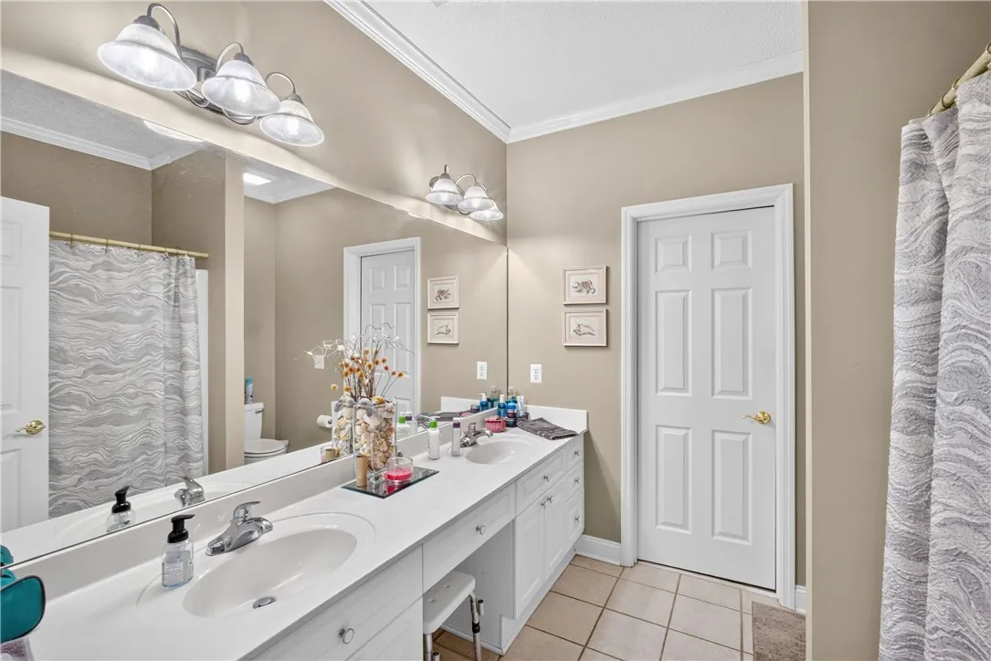 Dual vanity with bright lighting offers ample space and convenience.