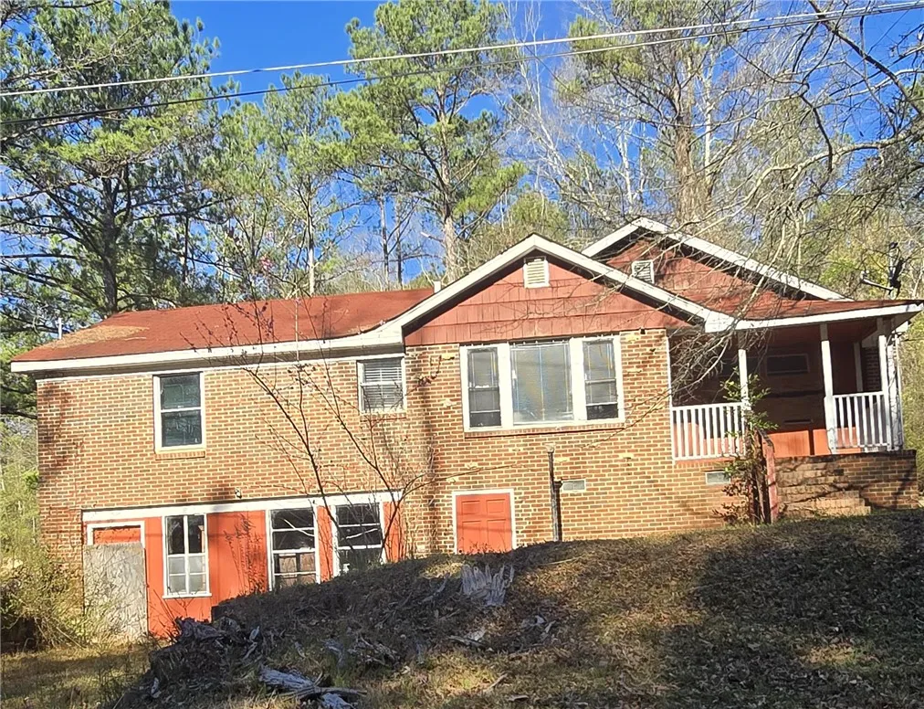 A classic brick exterior blends with natural surroundings, offering a welcoming facade.
