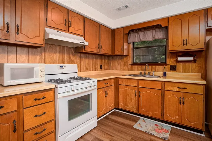 A well-appointed kitchen showcasing classic wood cabinetry and durable countertops.