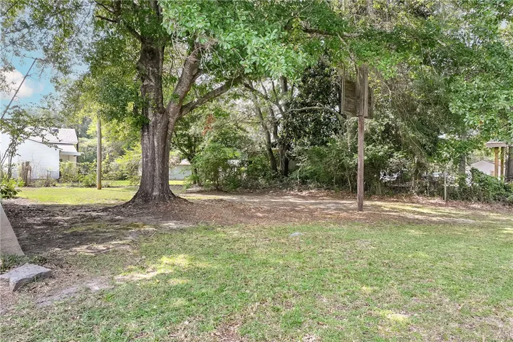 A spacious lot featuring mature trees and ample green space for outdoor enjoyment.