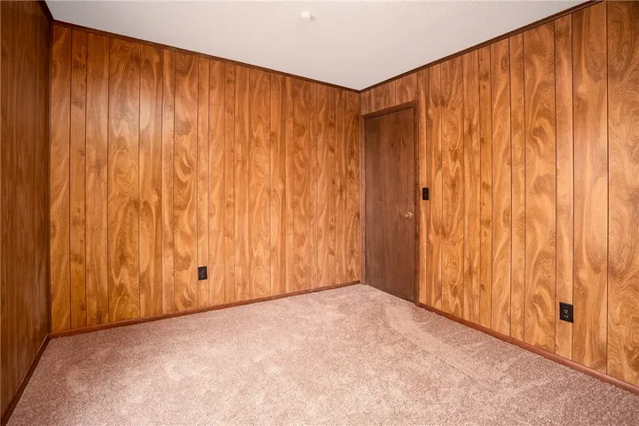 Warm wood paneling and soft carpeting define this cozy interior space.