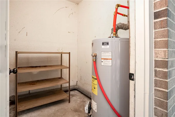 Functional utility space with a water heater and shelving for organized storage.