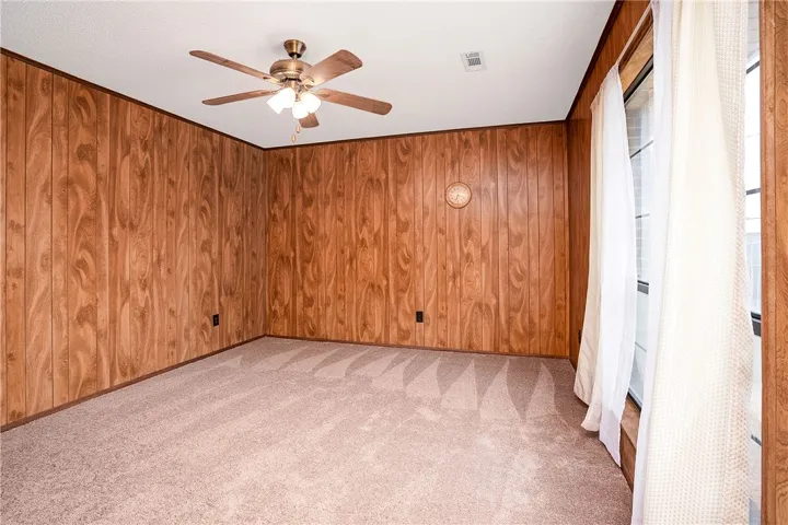 A comfortable room, well-lit by natural light, offers an inviting ambiance for daily living.