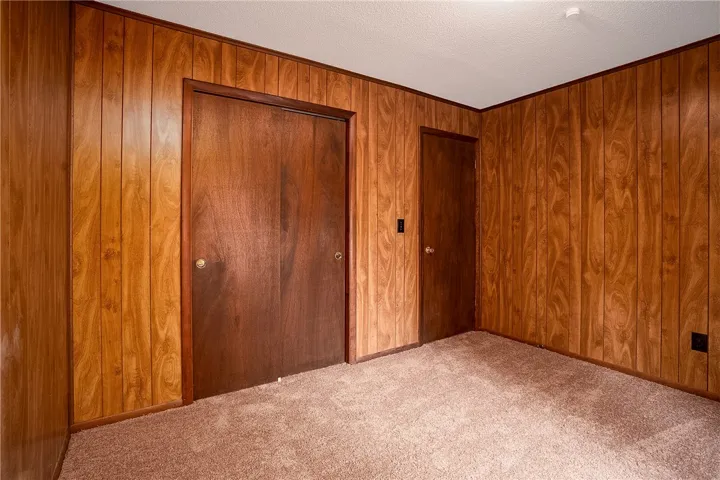 Wood paneling and soft carpeting define this inviting interior space.