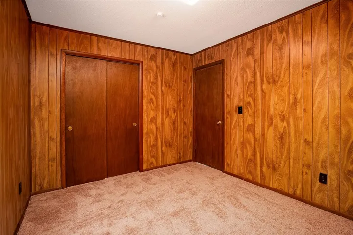 Rich wood paneling and soft carpeted floors define this inviting interior space.
