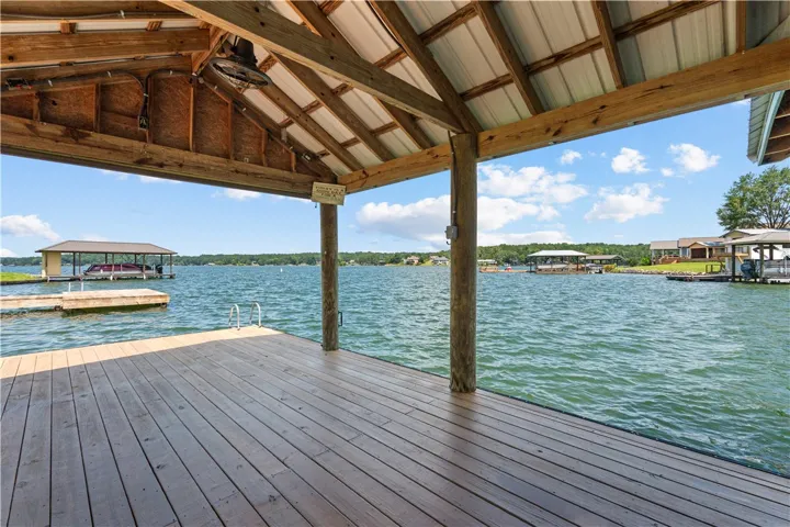 A spacious covered dock offers direct lake access and picturesque waterfront views.