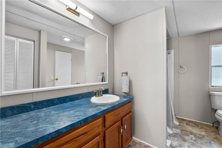Functional vanity and shower combination provide a comfortable and efficient bathroom space.