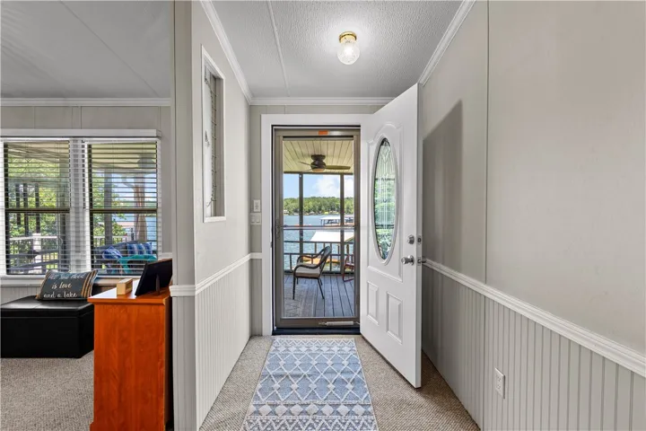 Step inside to a welcoming entry with direct views of the serene lake and expansive outdoor living space.