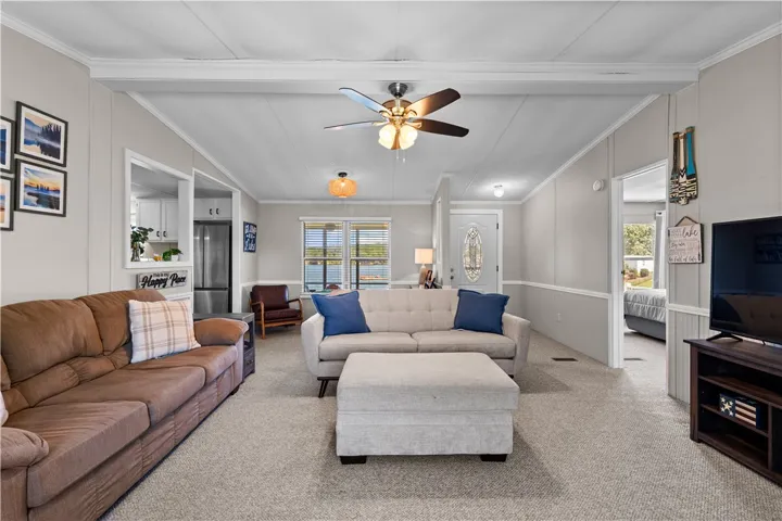 A comfortable living space offering direct lake views through a large window, perfect for serene relaxation.