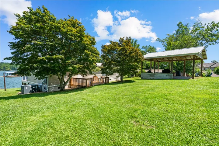 A spacious backyard with a private deck and waterfront access awaits, perfect for outdoor living and entertaining.