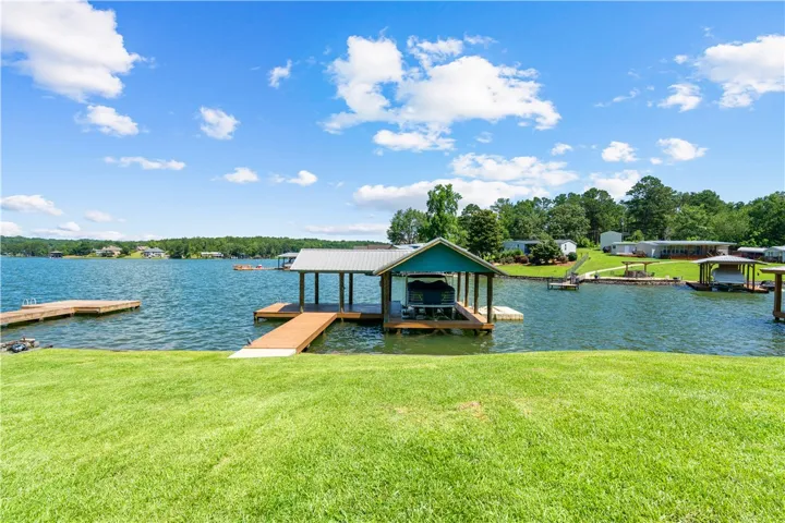 A tranquil lakefront property awaits, complete with a private boat dock and covered slip.