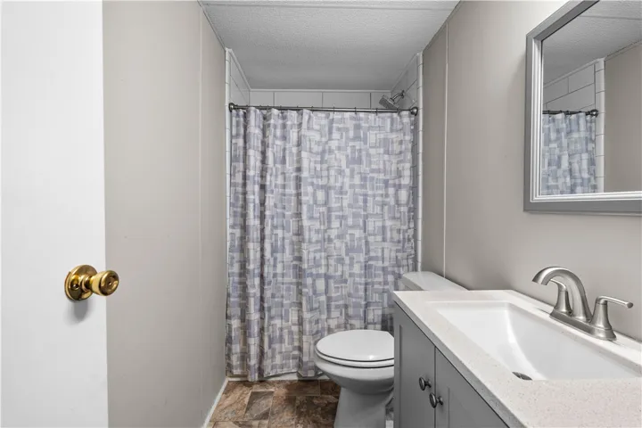 Modern fixtures and an updated vanity enhance this clean and functional bathroom space.