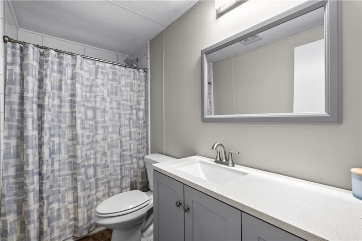 Modern vanity with a large mirror enhances this well-appointed bathroom.