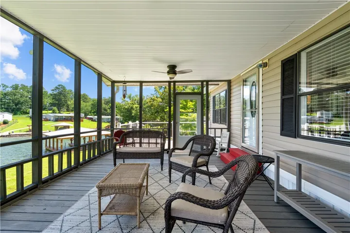 Enjoy tranquil water vistas from this inviting screened porch, perfect for relaxation and outdoor living.