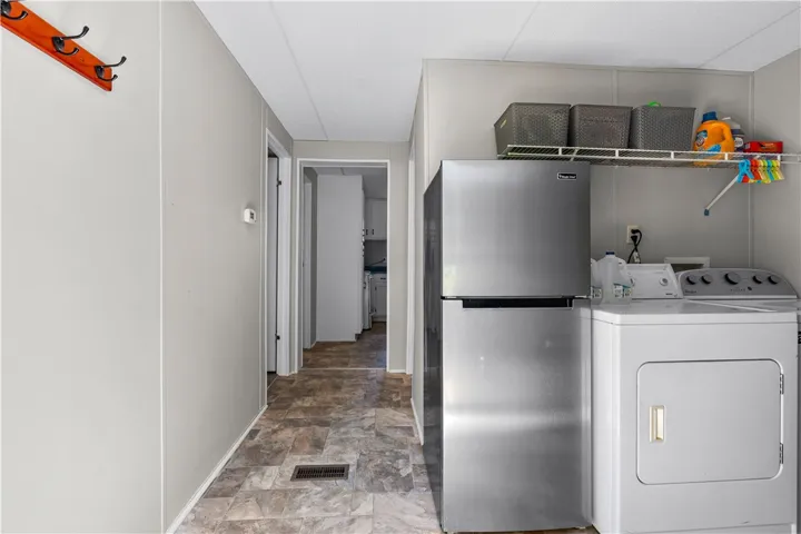 Functional laundry zone with essential appliances provides everyday convenience.