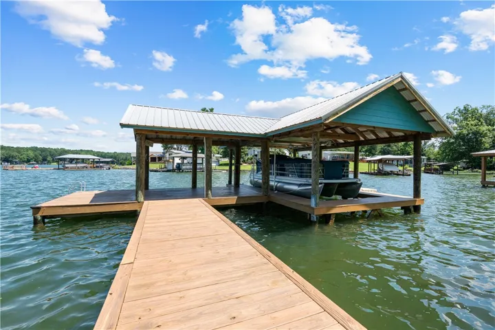 Secure boat moorage awaits with this well-maintained private dock featuring a covered boat slip.