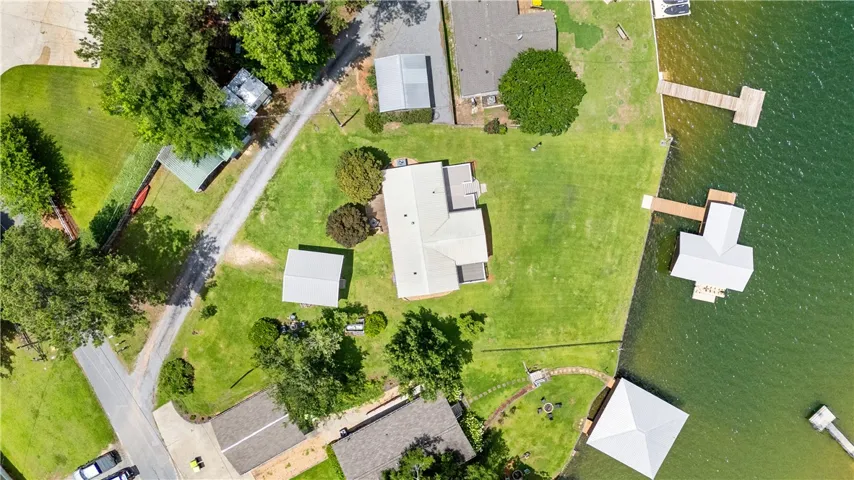 An aerial perspective reveals a serene waterfront property with ample green space and private boat docks.