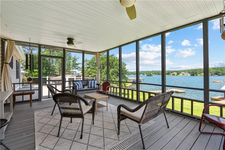A spacious screened porch offers unparalleled lake views, perfect for peaceful mornings or entertaining evenings.