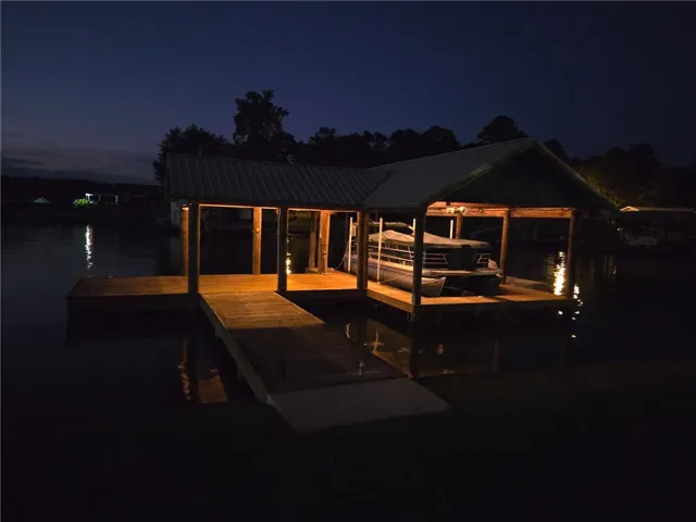 Illuminated boat dock provides direct water access and covered boat storage.