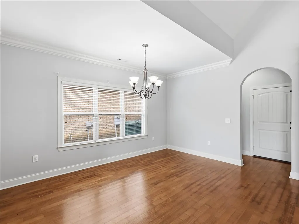 Hardwood floors and graceful crown molding define this versatile interior space.