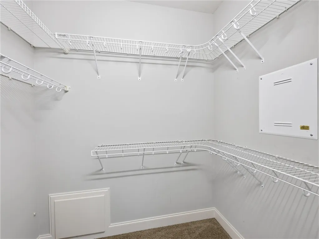 Functional wire shelving optimizes storage within this well-appointed closet.