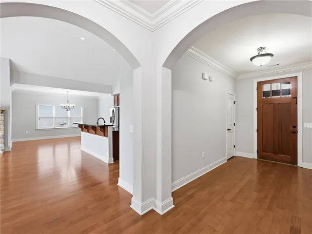 Rich hardwood floors welcome you into this inviting interior, featuring graceful archways.