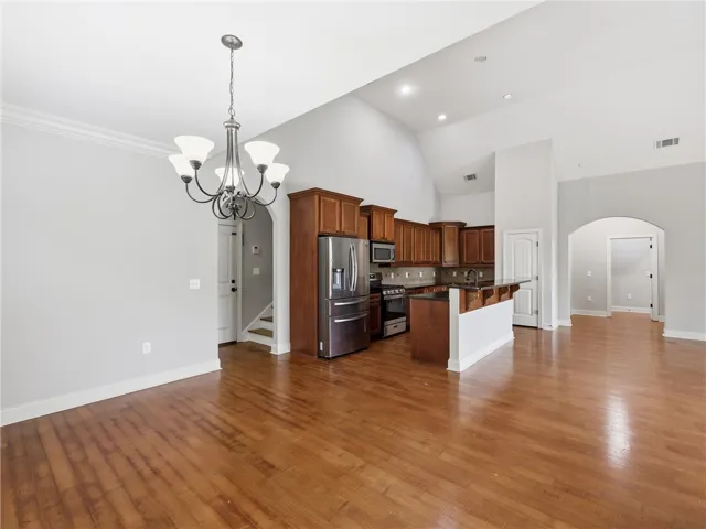 Hardwood floors and soaring vaulted ceilings define this inviting kitchen and dining area.